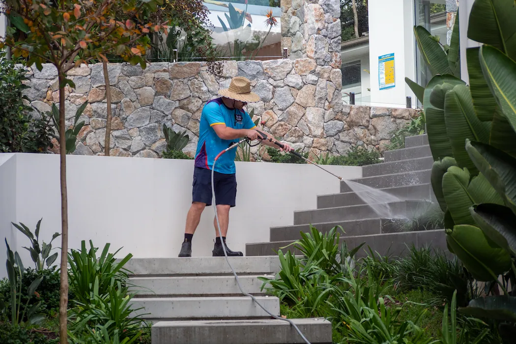 Kleen Genie technician pressure washing concrete steps