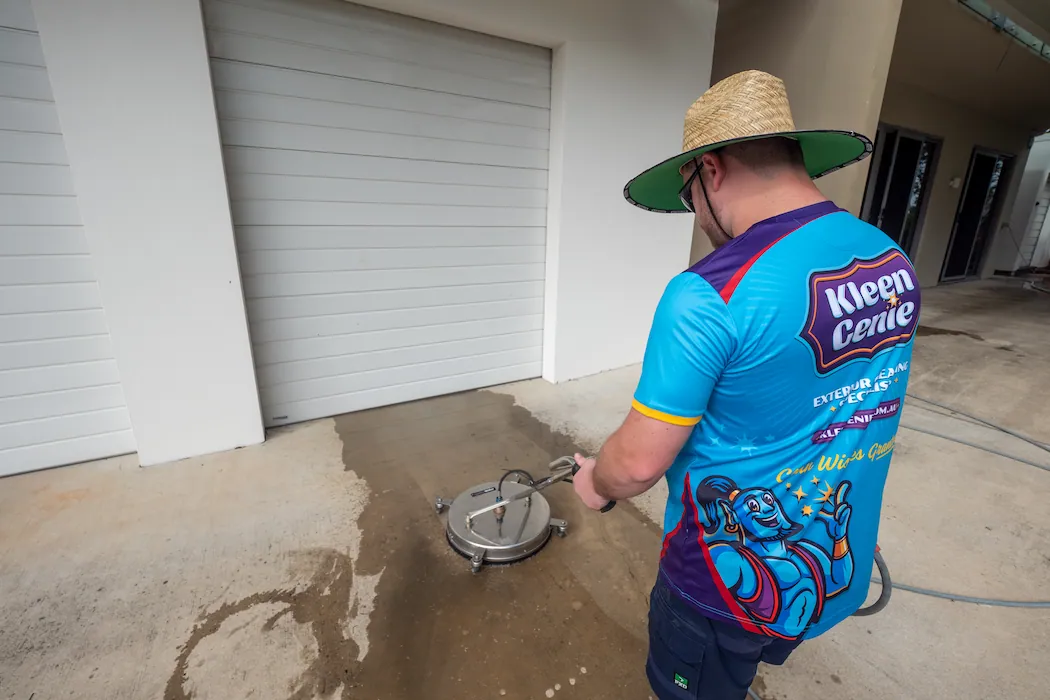 kg-pressure-washing-3 Kleen Genie technician using high-powered pressure cleaning equipment on a driveway