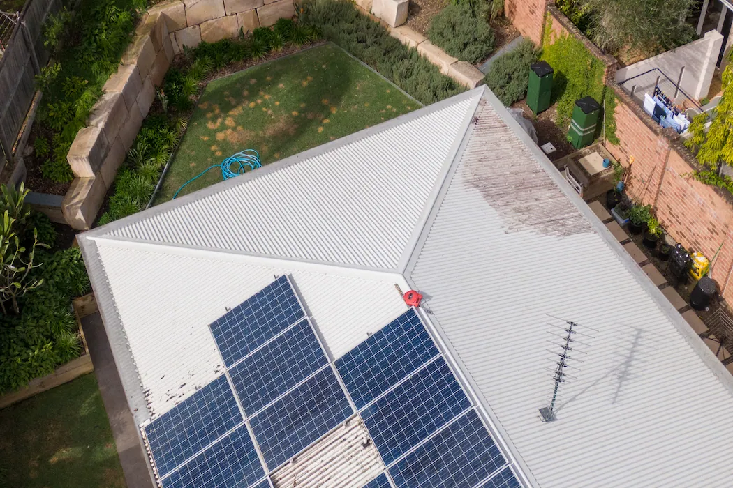 kg-solar-panel-cleaning-2 Aerial drone perspective of Australian corrugated roof with solar panels